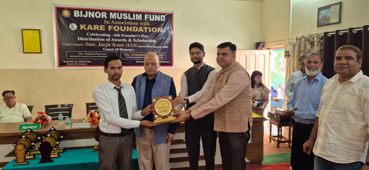 Student receiving research scholarship award from officials - 2025