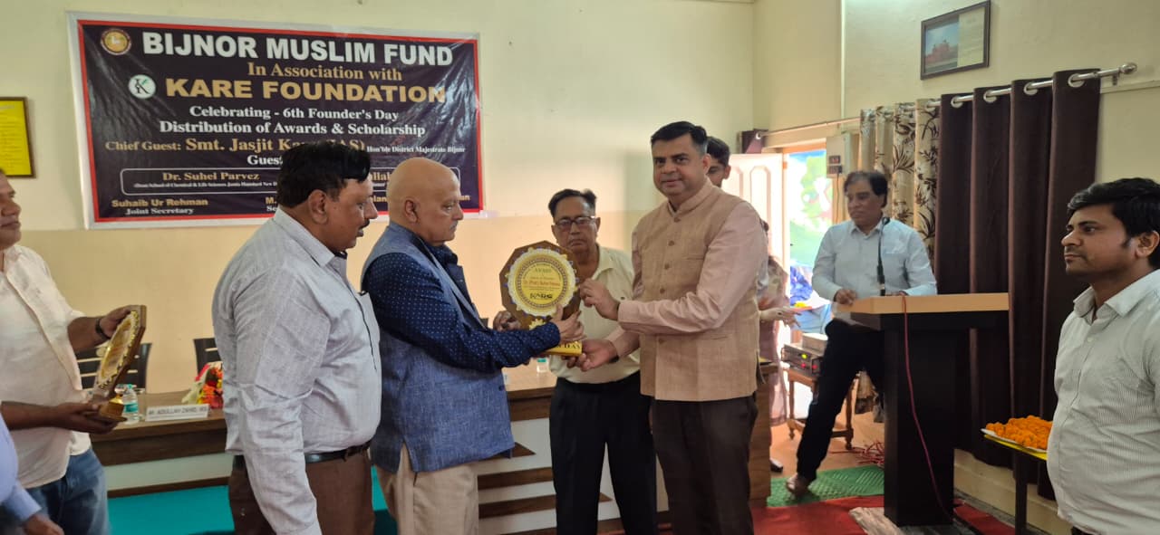 Foundation trustees presenting research scholarship to student - 2025